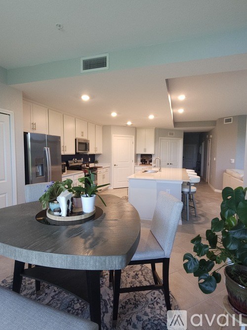 A modern kitchen with a dining table and chairs.