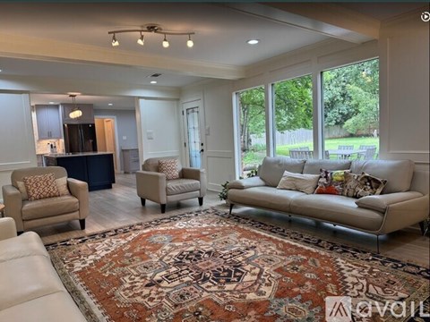 A living room with a rug and a couch.