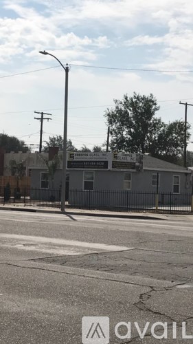 A street view with a building and a sign that says "available".