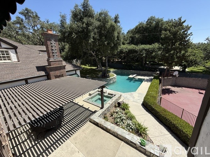 A backyard with a pool and a hot tub.