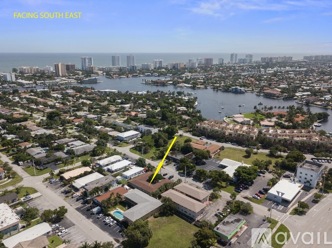 A bird's eye view of a residential area with a yellow line indicating a specific location.