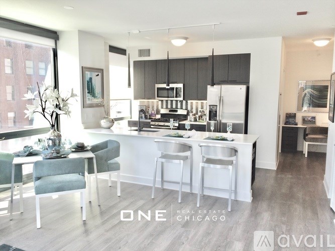 A modern kitchen with a dining table and chairs.