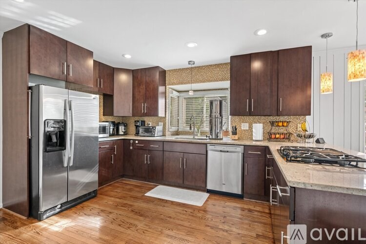 A kitchen with wooden cabinets and a refrigerator.