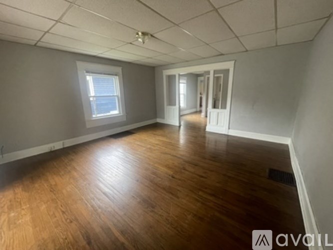 A room with wooden floors and a ceiling fan.