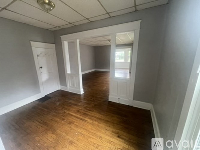 A room with wooden floors and white doors.