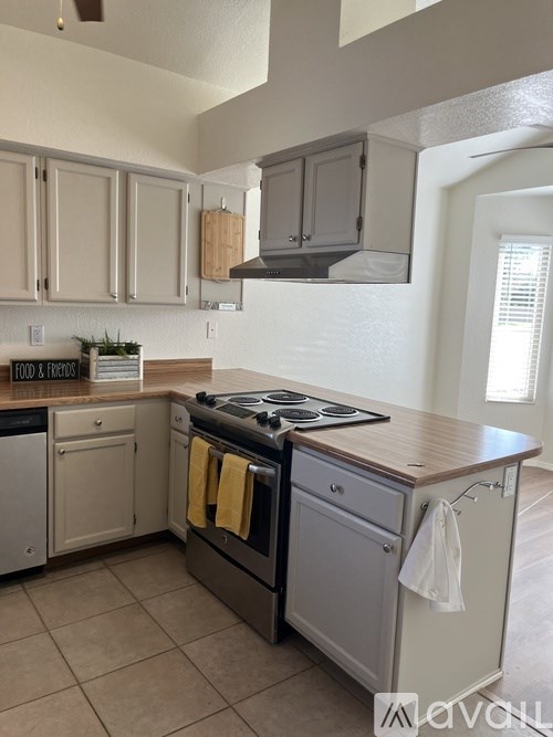 A kitchen with a stove top oven and a dishwasher.