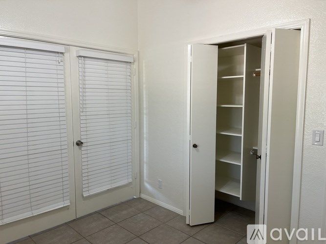 A white door with a glass panel is open.