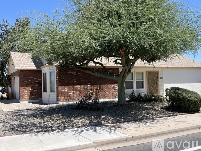 A house with a tree in front of it.