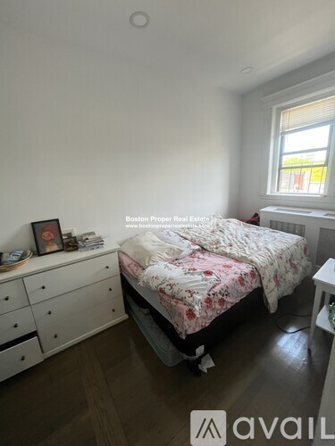 A bedroom with a bed, nightstand, and a dresser.