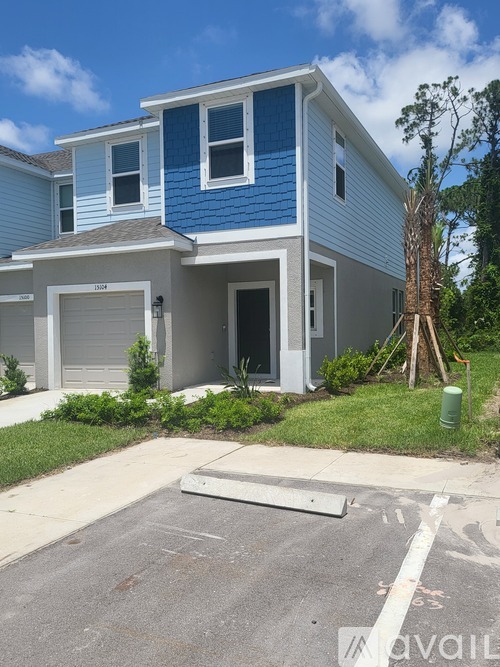 A two-story house with a blue and white exterior.