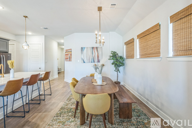 A dining room with a round table and chairs.
