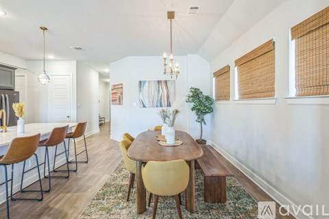 A dining room with a round table and chairs.