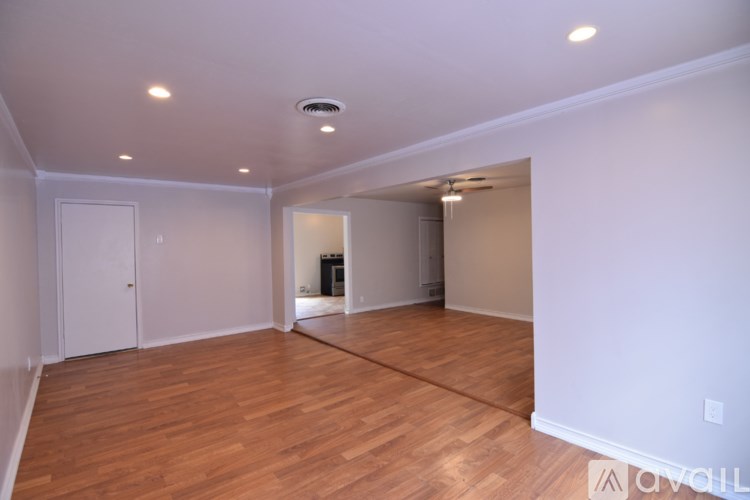 A room with wooden floors and white walls.