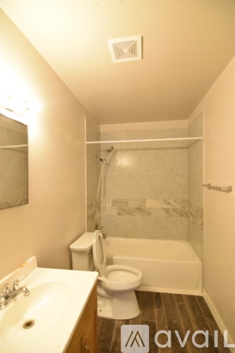 A bathroom with a sink, toilet and bathtub.