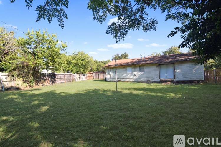 A kitchen with black appliances and brown cabinets.