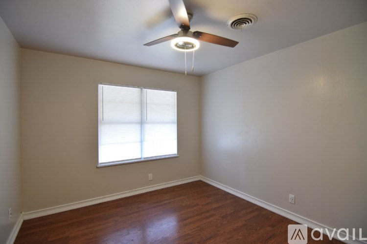 A room with a ceiling fan and a window.