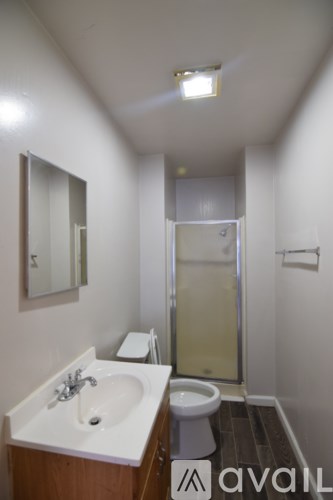 A bathroom with a sink, toilet and shower.