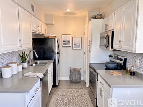 A kitchen with a stainless steel sink and dishwasher.