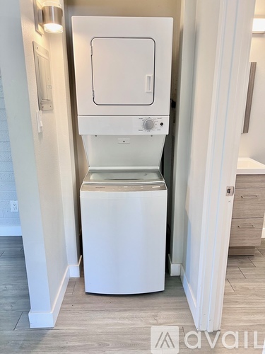 A white washing machine in a small laundry room.