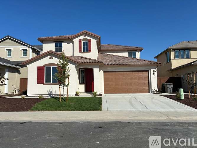 A house with a brown garage door is for sale.