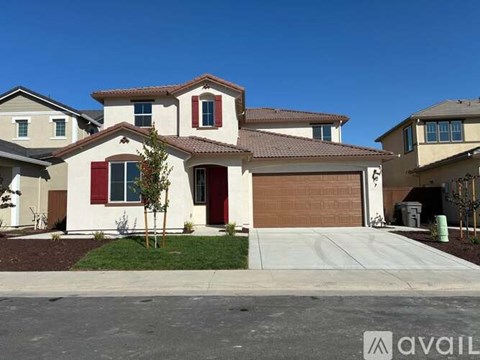 A house with a brown garage door is for sale.