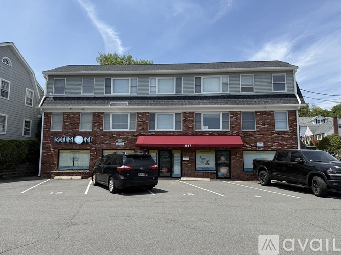 A building with a red awning and the word "KUMON" on it.