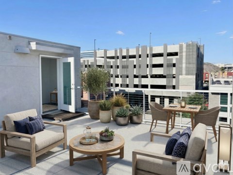 A modern building with a large garage door is for sale.