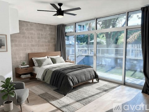 A spacious room with a staircase and a ceiling fan.