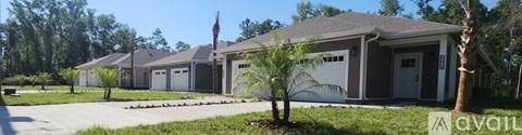 A row of houses with a sign that says "available" in front of the first one.