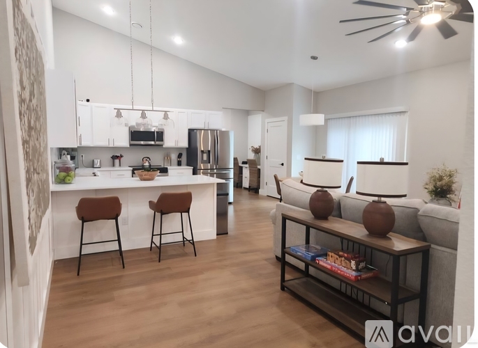 A modern kitchen with a dining table set for two.