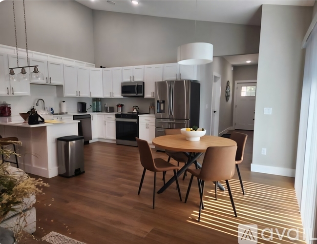 A modern kitchen with a dining table set up.