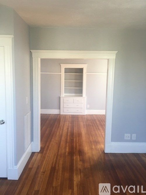 A room with wooden floors and white walls.