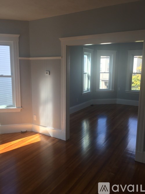 A room with wooden floors and a white door.