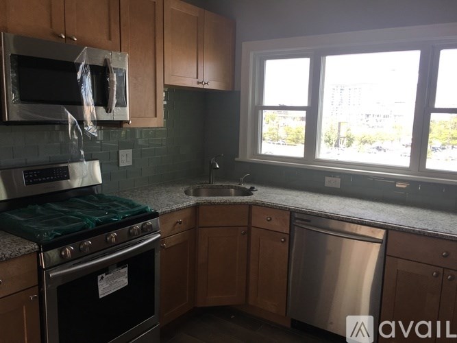 A kitchen with a stove top oven and a dishwasher.