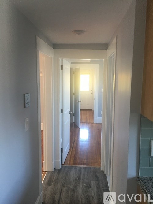 A hallway with a light at the end.
