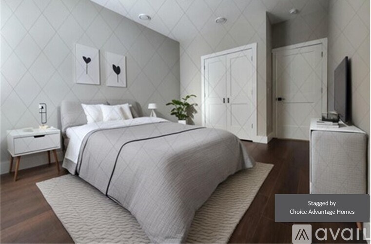 A bedroom with a large bed and a television on a stand.