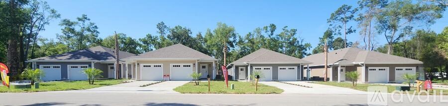 A row of houses with garages are for sale.