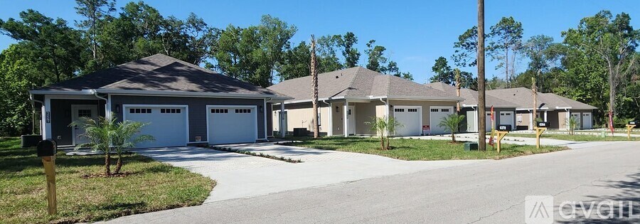 A row of houses with garages are shown in a residential area.