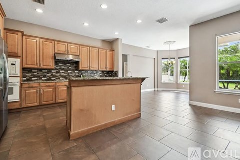 A kitchen with wooden cabinets and a tiled backsplash.