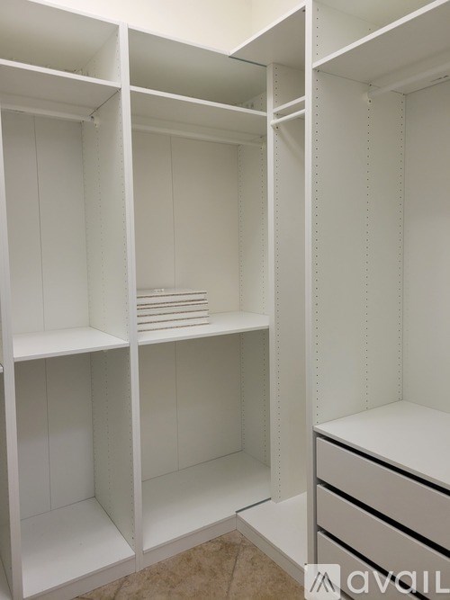 A room with light blue walls and a ceiling fan.