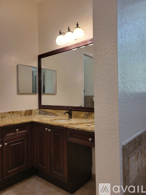 A spacious room with a ceiling fan and tile flooring.