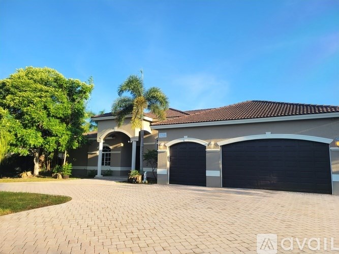 A room with a tiled floor and a window with blinds.