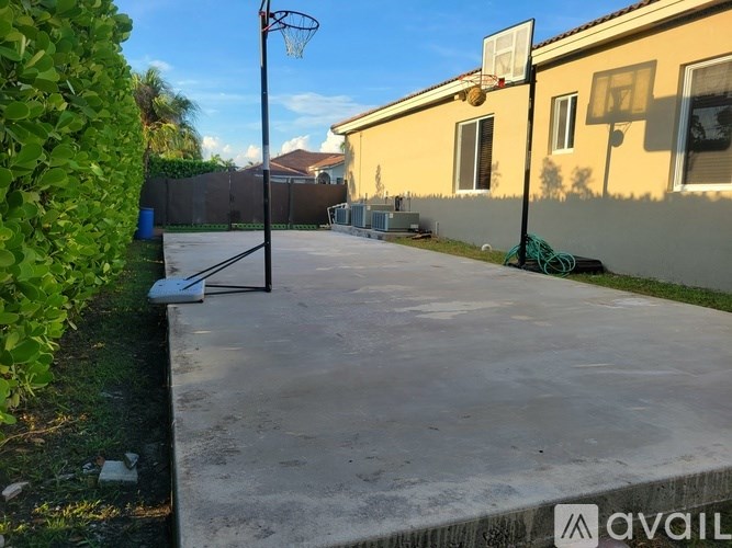 A room with tiled flooring and a window with blinds.