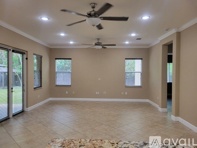 A basketball hoop is mounted on a pole in a backyard.