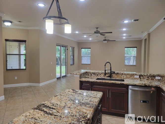A kitchen with granite countertops and a center island.