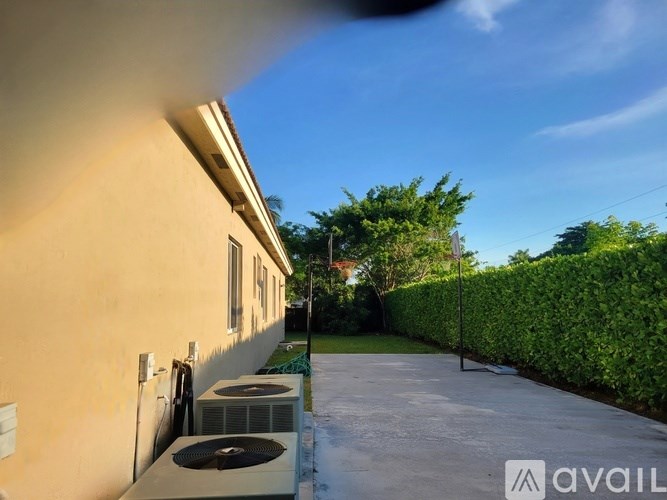 A house with a wall-mounted air conditioner unit.