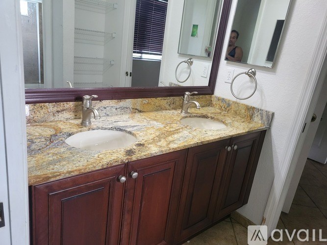 A bathroom with a marble countertop and a sink.