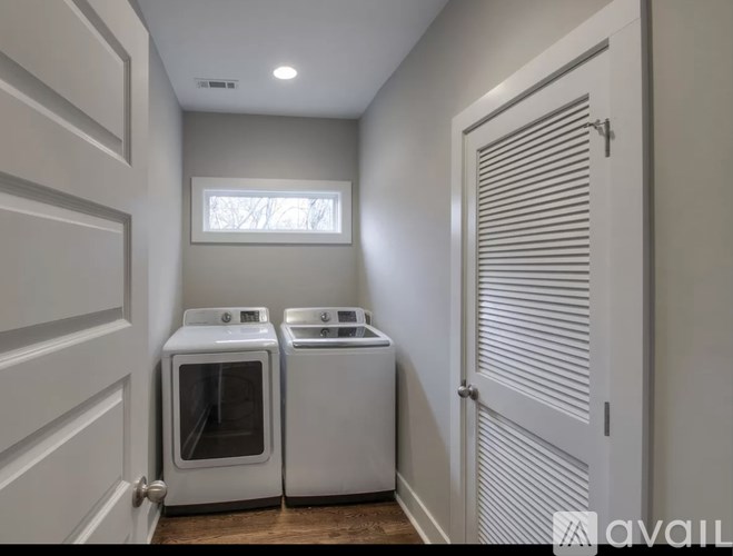 A small kitchen with a white oven and microwave.