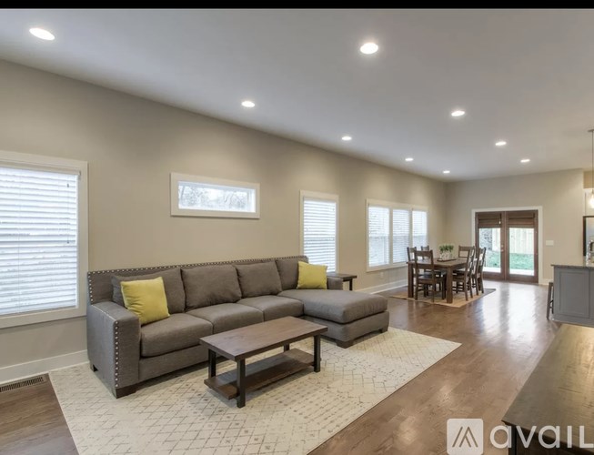 A living room with a grey sofa and a coffee table.