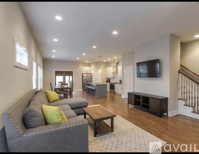 A living room with a grey couch and a wooden coffee table.